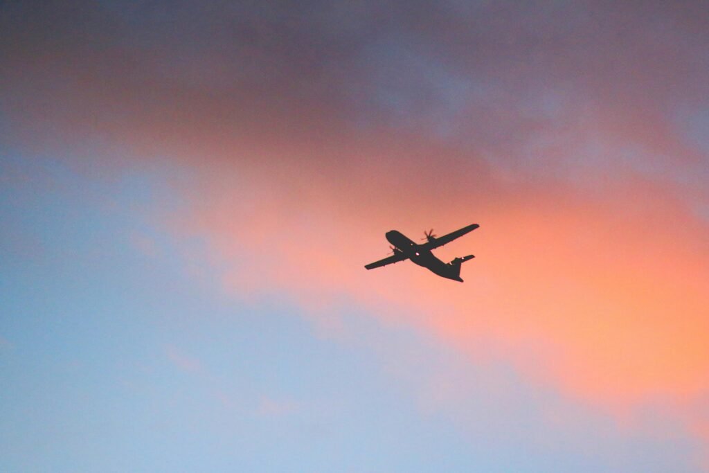 pexels-photo-1161161-1161161 Silhouette of an airplane flying against a colorful sunset sky, symbolizing travel and adventure.